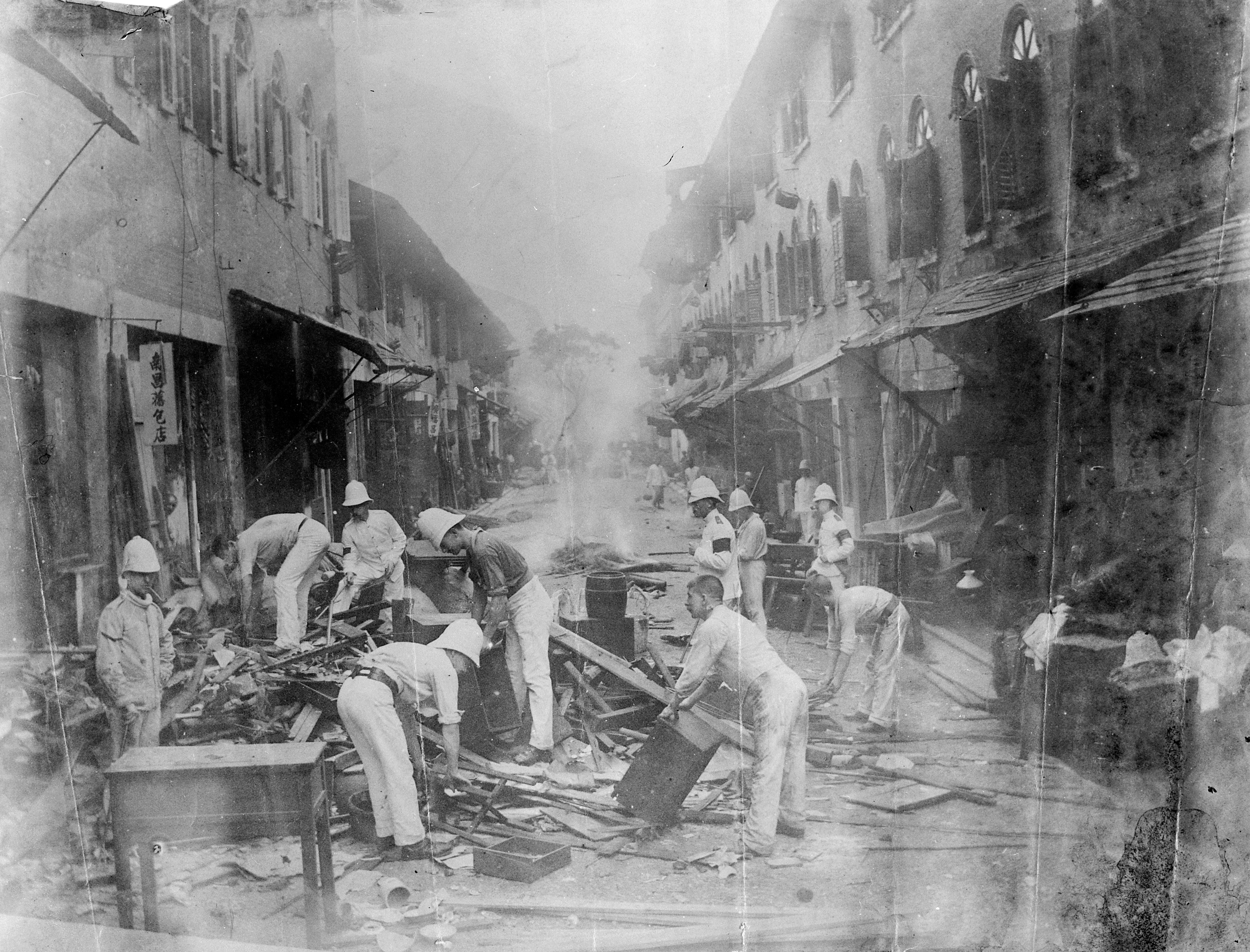Photograph of the Shropshire Regiment cleaning plague houses in Taipingshan, Hong Kong, 1894 — soldiers in white limewashing buildings